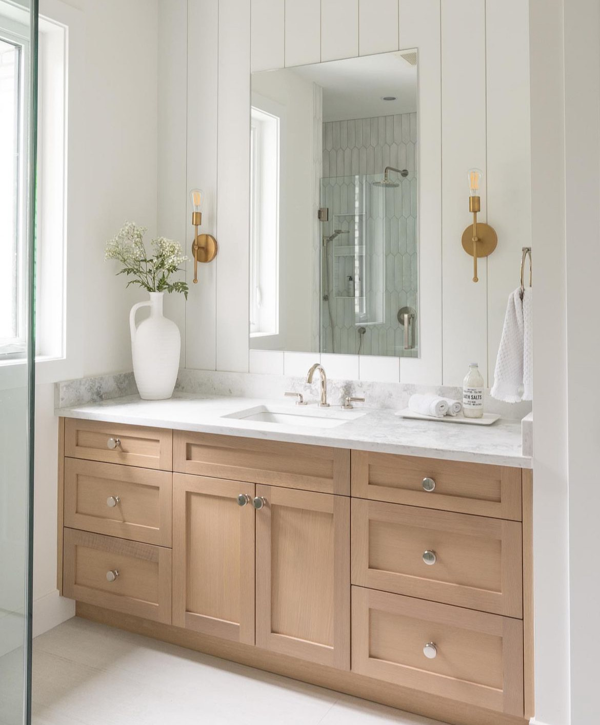 Tsawwassen Residence — secondary bathroom with white oak vanity, marble counter, and brass sconces
